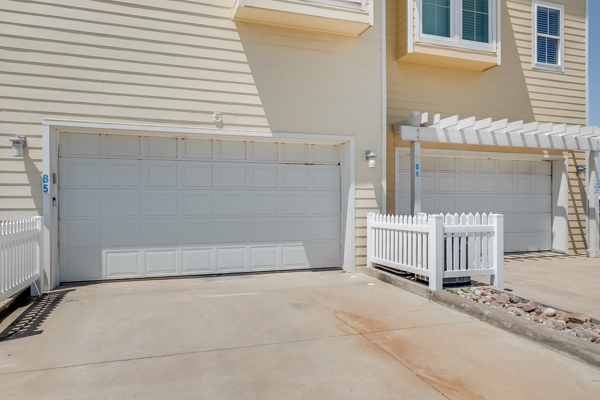 Spacious garage with direct property access and convenient outdoor stairs to upper levels.