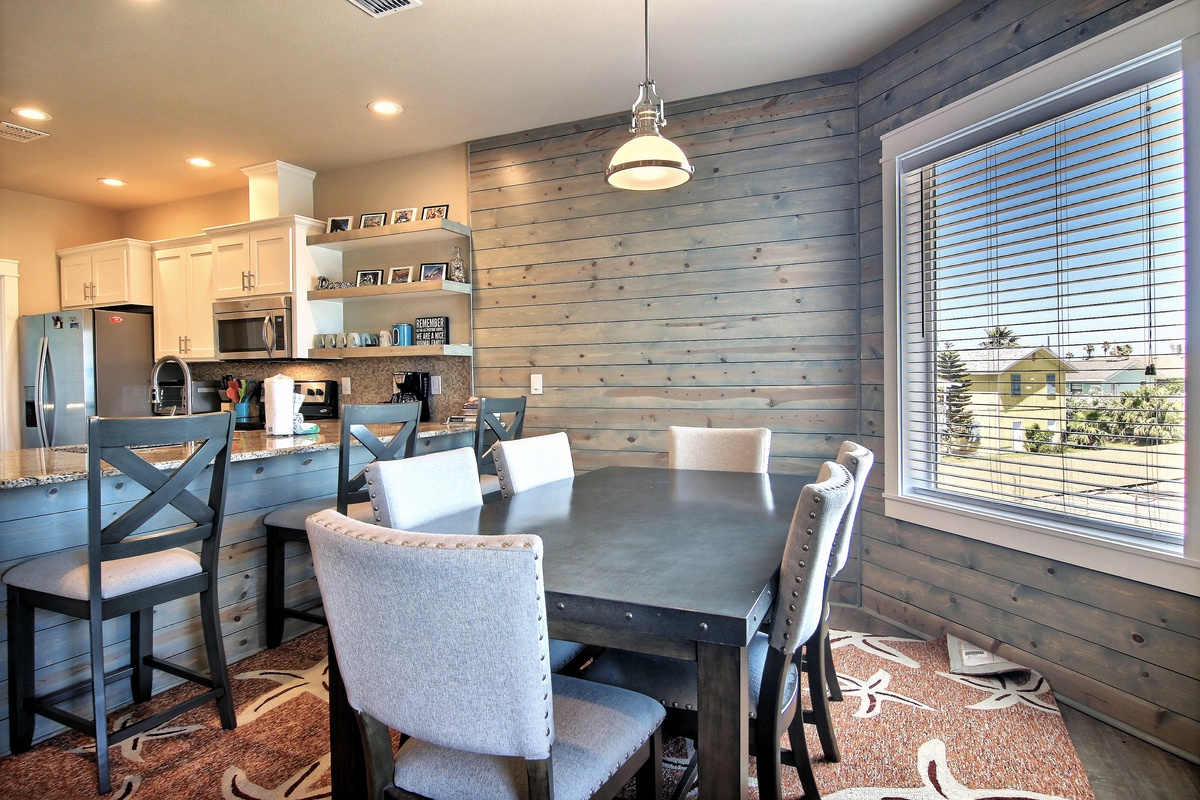 Gather around your stylish dining table where rustic wood meets modern comfort, perfect for memorable meals with stunning views beyond.