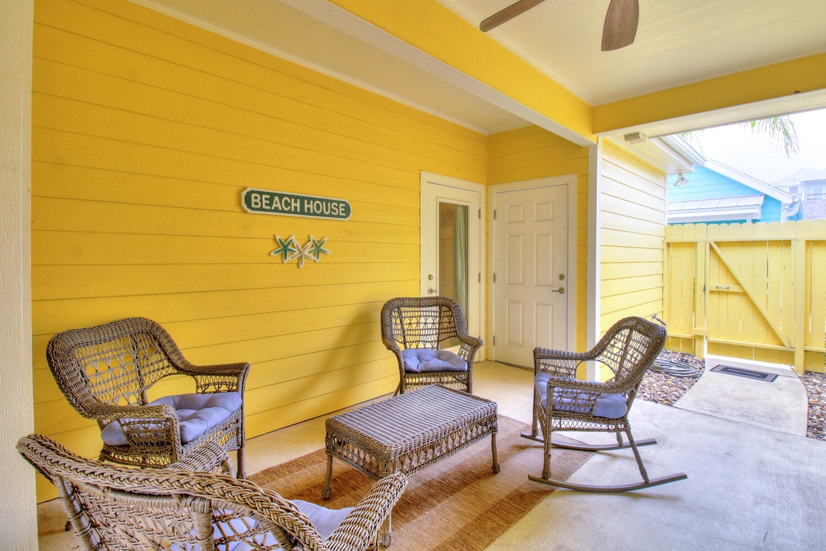 Relax on your covered porch with cozy wicker seating and that perfect beach house charm welcoming you home.