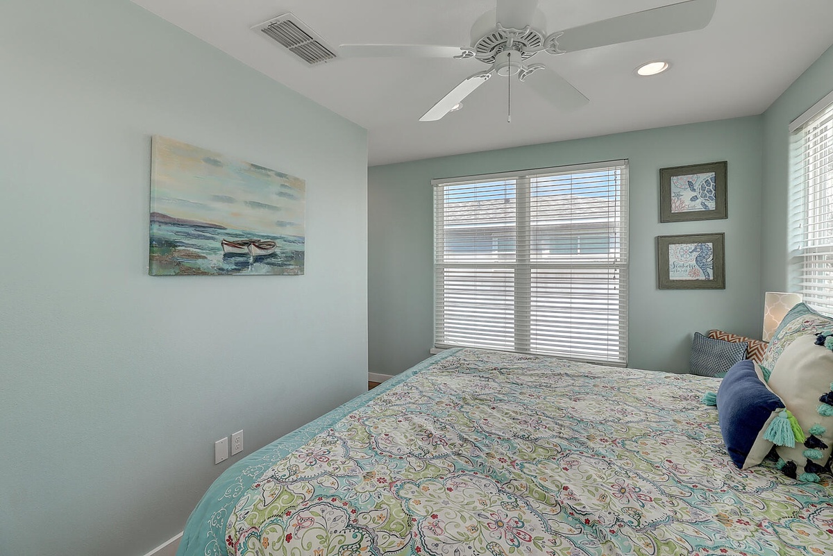 Wake up refreshed in this tranquil coastal bedroom where soft seafoam walls and ocean artwork create your perfect seaside retreat.