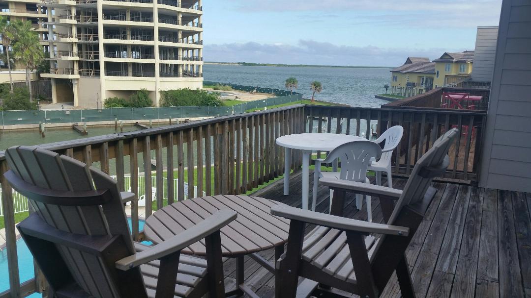 Your private balcony overlooks stunning bay waters, featuring comfortable seating where you can start mornings with coffee or unwind as gentle breezes carry the peaceful sounds of the waterfront.