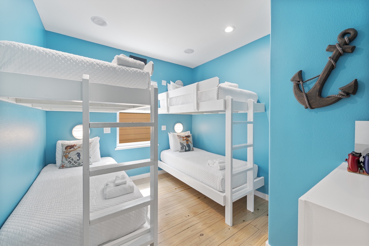 Your crew will love these twin bunk beds in a cheerful coastal-blue room with playful nautical accents and plenty of space to unwind after beachside adventures.