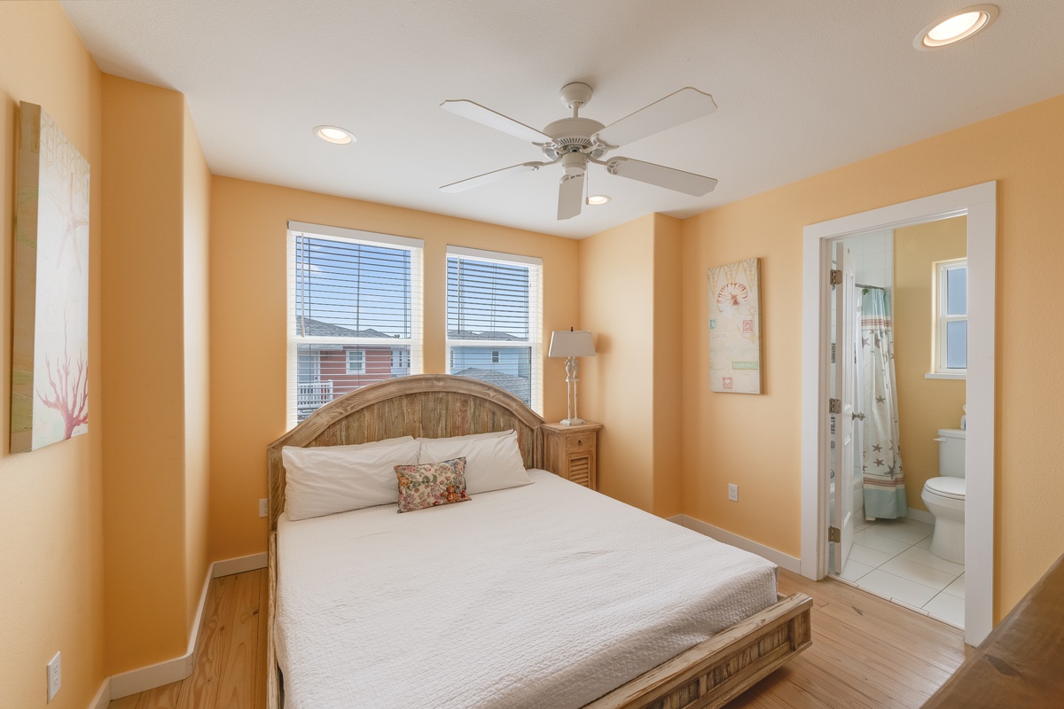 Unwind in your cheerful bedroom with warm orange walls, plush bedding, and gentle ceiling fan keeping you comfortable year-round.