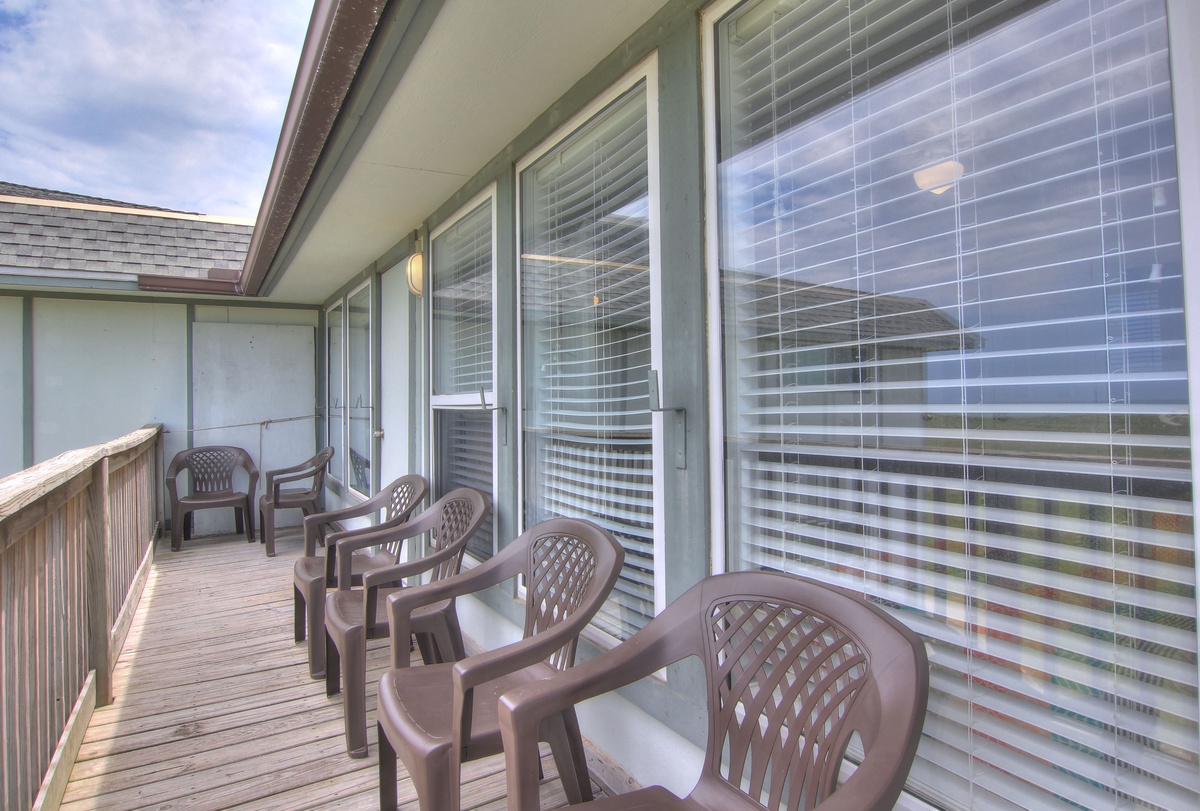 Step onto your private balcony where comfortable chairs await for morning coffee or evening relaxation with ocean breezes.