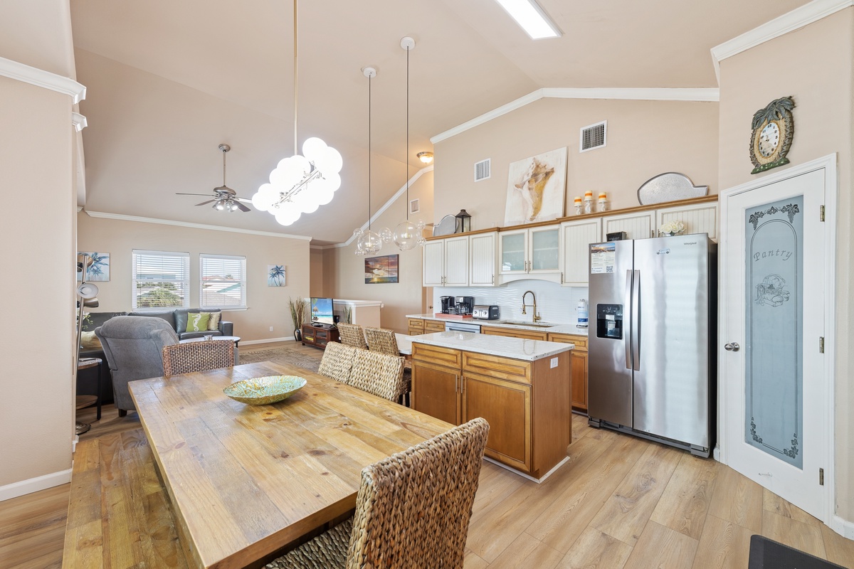 Gather around the dining table or enjoy casual seating at the kitchen island in this bright, open-concept living space.