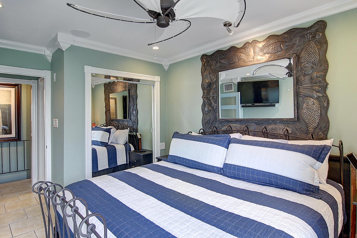 Drift off in your oceanside bedroom with soothing sea-green walls and crisp nautical linens beneath tropical ceiling fans.