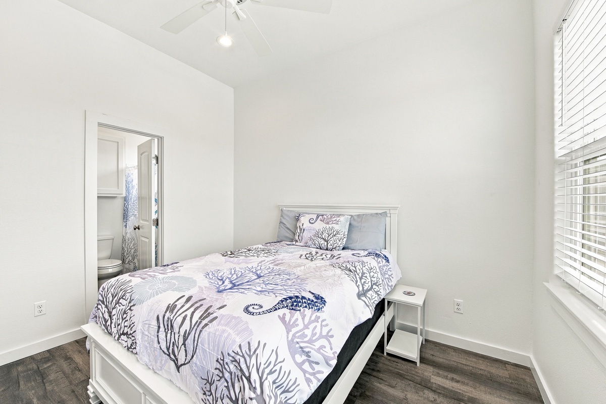 Slip into a peaceful night's rest in your bright and airy primary bedroom, where clean white walls and natural light create the perfect retreat after a day of adventure.
