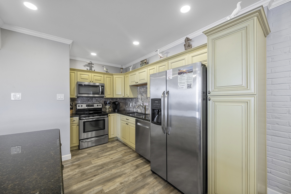 Your fully-equipped kitchen features stainless steel appliances and warm cabinetry, perfect for preparing memorable meals during your stay.