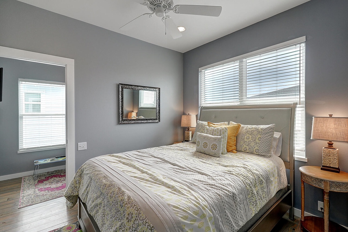 Sink into your comfortable bed surrounded by soothing gray walls and natural light from large windows.