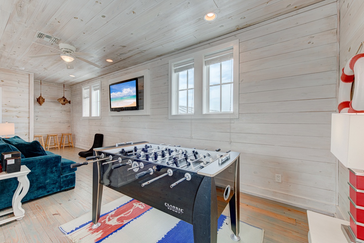 Challenge family and friends to exciting foosball matches in your private game room, complete with cozy seating and entertainment.
