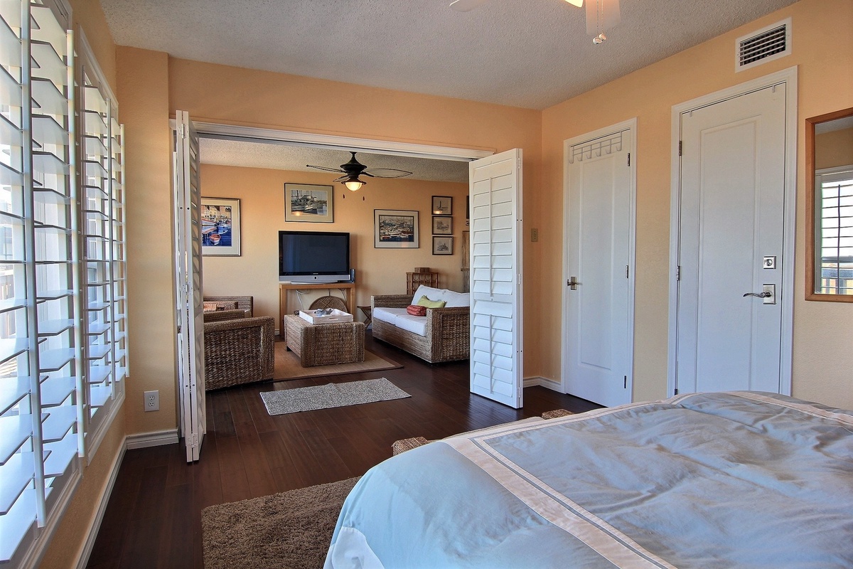 Relax in your spacious suite with elegant wicker furniture, flat-screen TV, and warm coastal decor creating the perfect retreat.