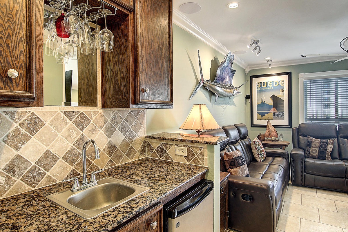 Unwind in your coastal-themed retreat with granite counters, elegant cabinetry, and plush leather seating where nautical charm meets modern comfort.