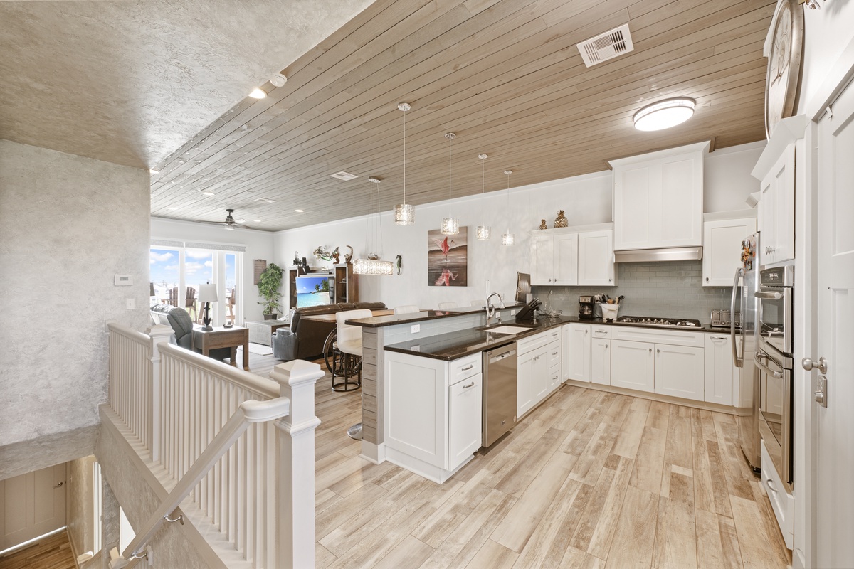 Your spacious gourmet kitchen flows seamlessly into the living area, creating the perfect space for cooking memorable meals together.