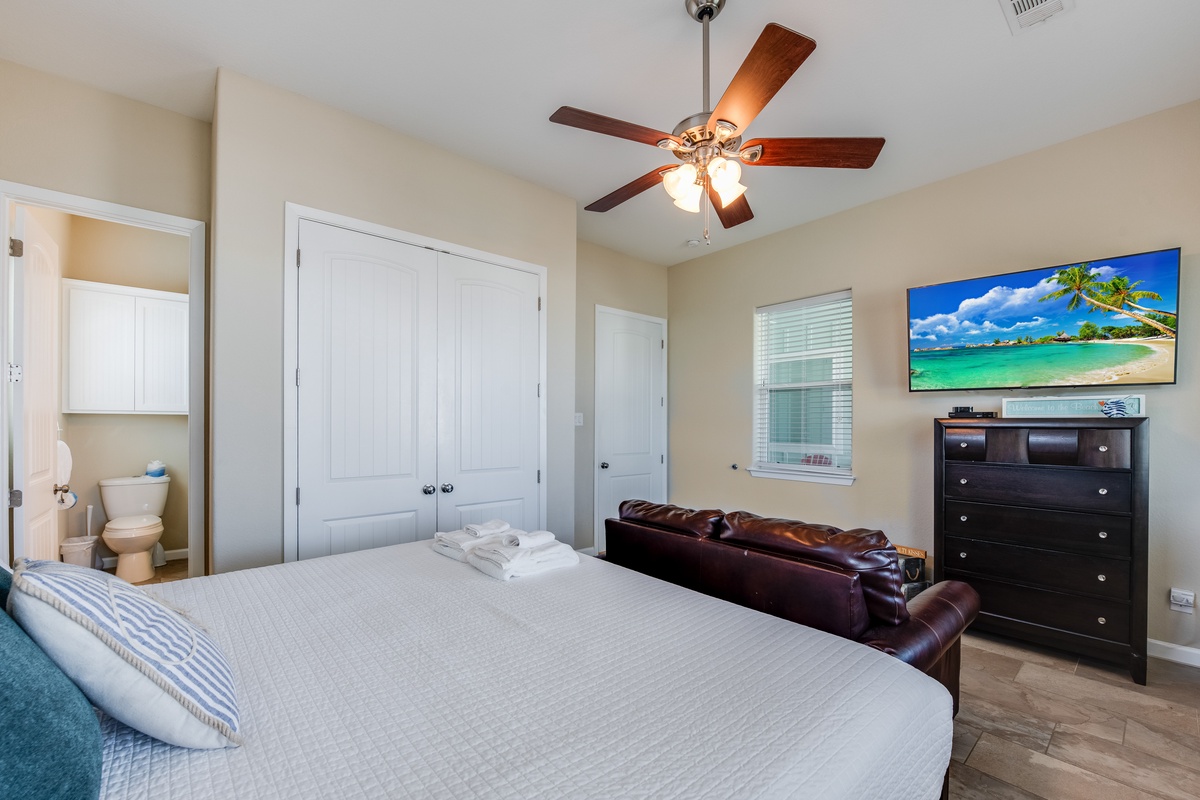 Sink into your comfortable bed while the ceiling fan keeps you cool. Your private bathroom awaits just steps away.