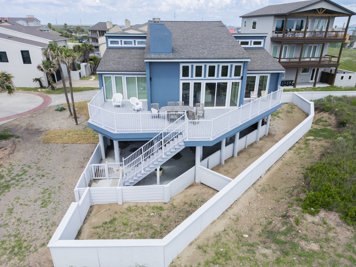 Elevated beachside property featuring expansive deck spaces and modern coastal architecture in a peaceful residential neighborhood.