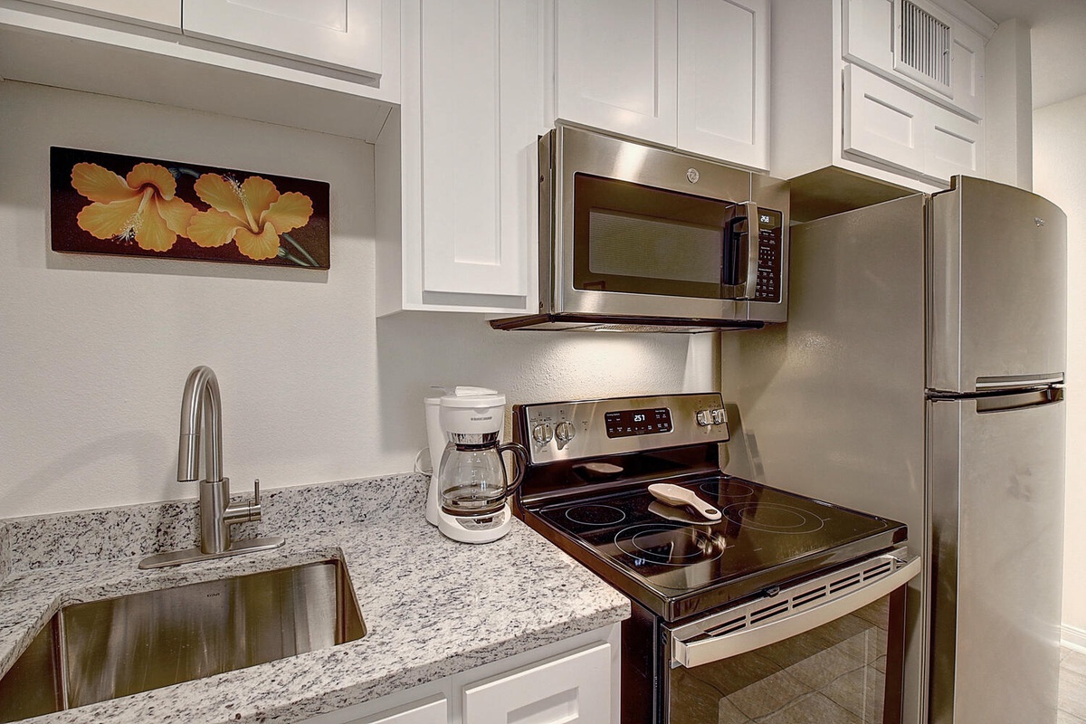 Your fully equipped kitchen features granite countertops, stainless steel appliances, and everything needed to create memorable meals during your stay.