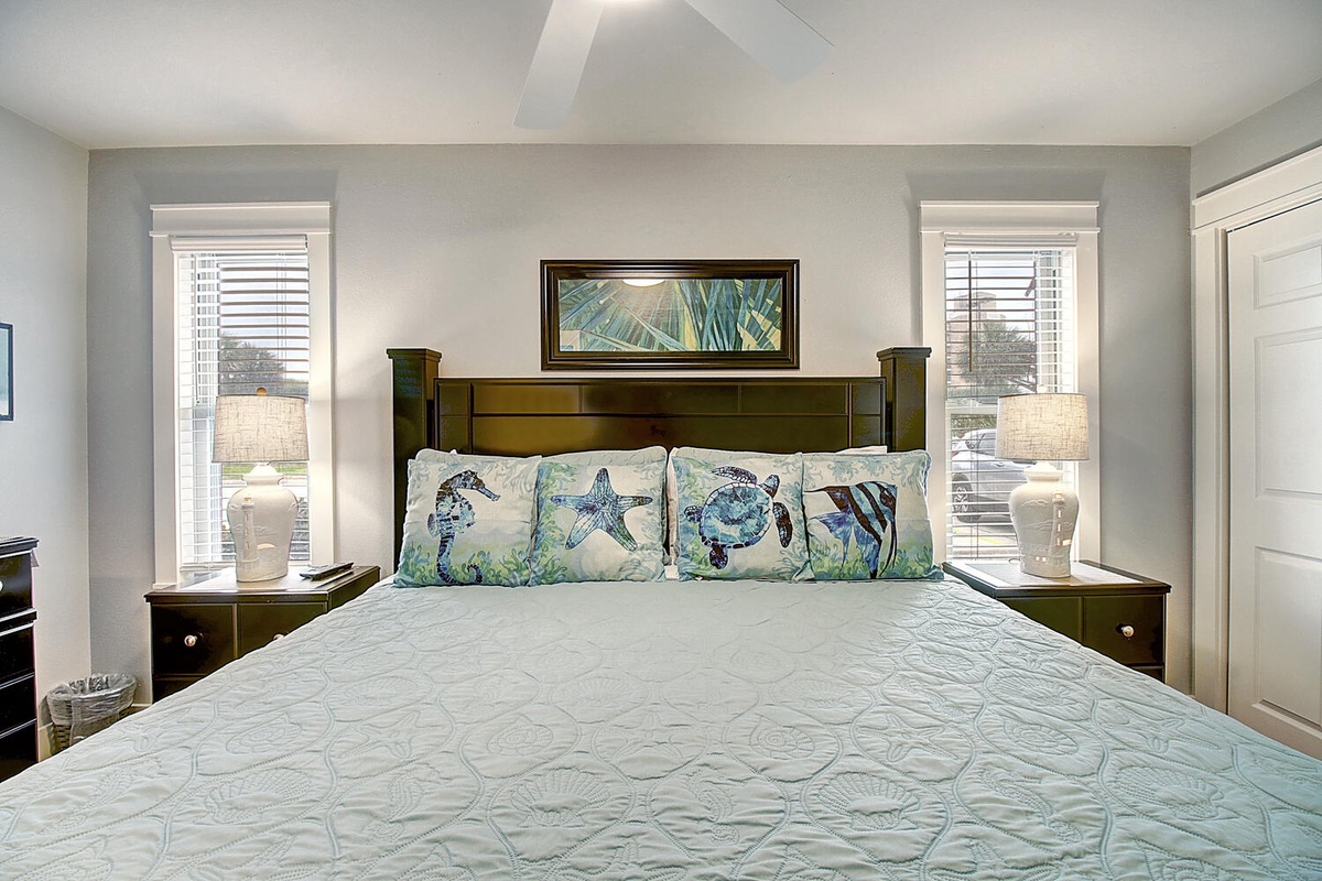 Sink into this tranquil bedroom where ocean-themed pillows and soft linens promise restful nights in your coastal-inspired retreat.