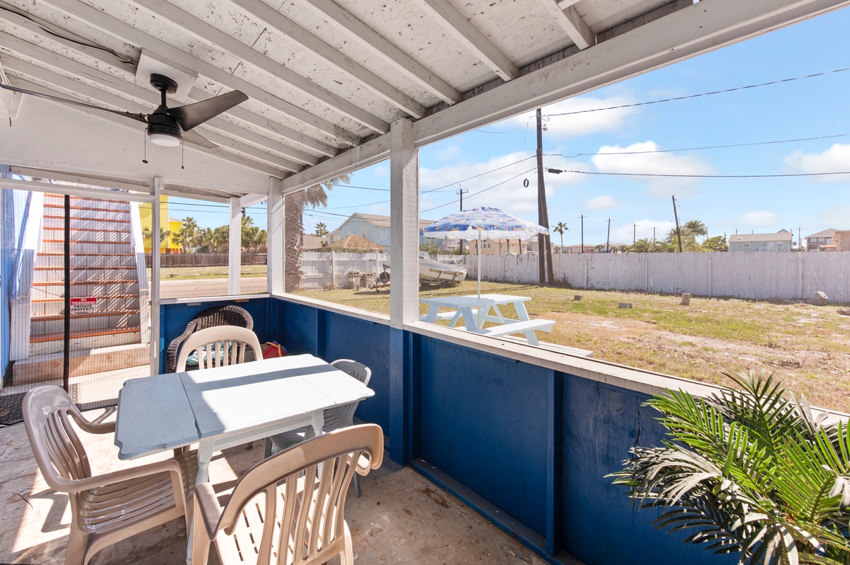Enjoy morning coffee on your covered patio with comfortable seating and gentle breezes flowing through this bright outdoor space.