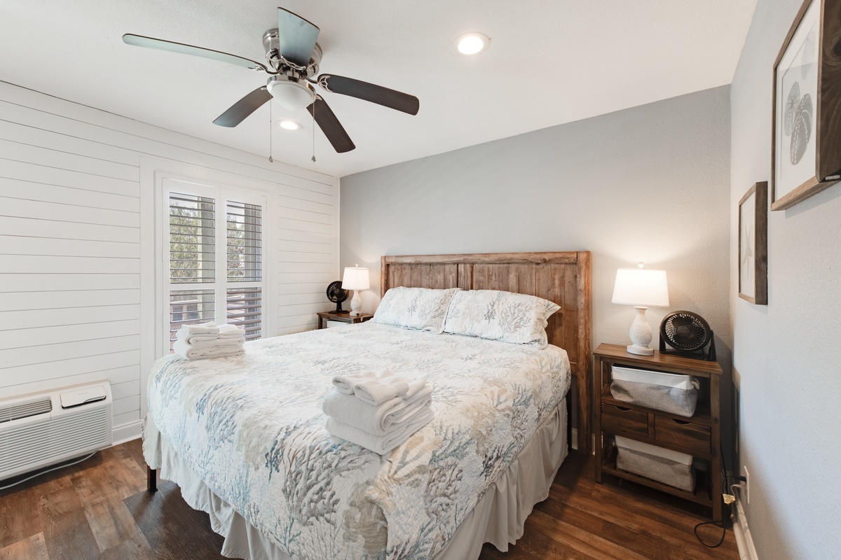 Unwind in your peaceful bedroom with rustic charm, soft linens, and gentle ceiling fan keeping you comfortable all night.