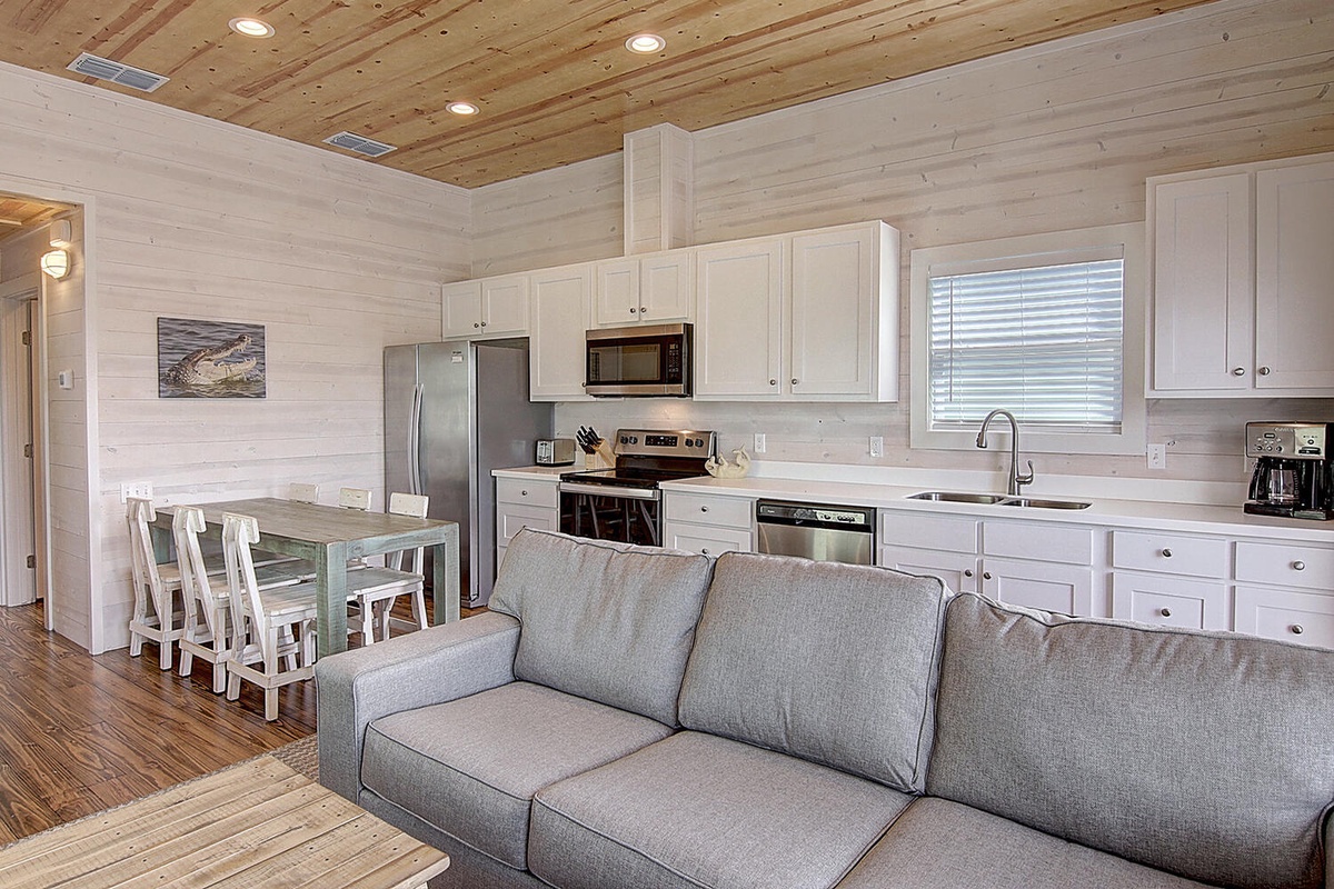Relax in your open-concept retreat where modern comfort meets coastal charm. The fully equipped kitchen and cozy living area create perfect spaces for memorable moments.
