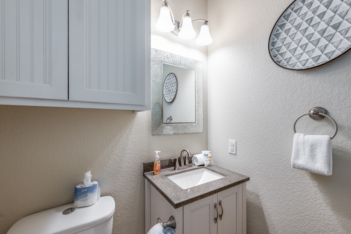 Relax in your spotless bathroom featuring granite counters, white cabinetry, and thoughtful touches that make your stay feel like home.