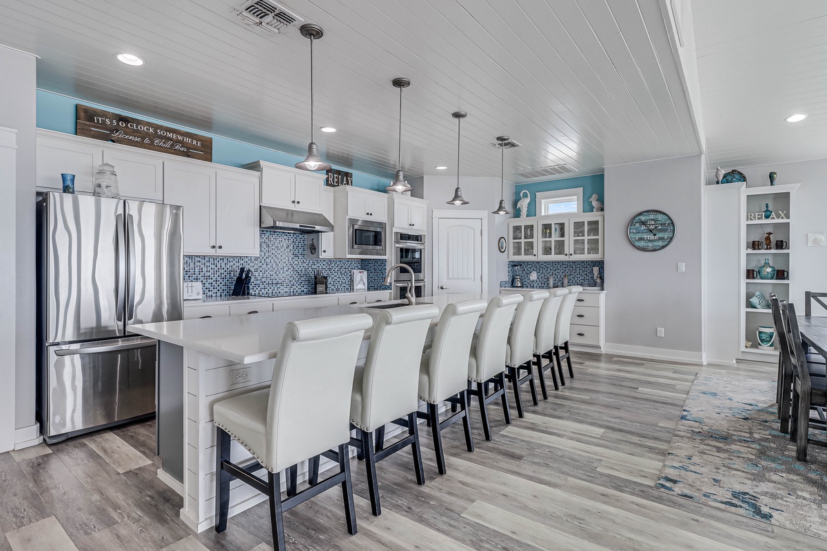 Gather around your spacious kitchen island for morning coffee or evening conversations in this bright, coastal-inspired space.