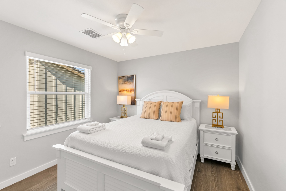 Rest peacefully in this cozy bedroom with crisp linens, warm lighting, and gentle ceiling fan keeping you comfortable all night.