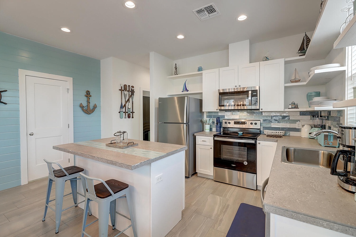 Cook your favorite meals in this bright, coastal-themed kitchen with modern appliances and charming nautical touches throughout.