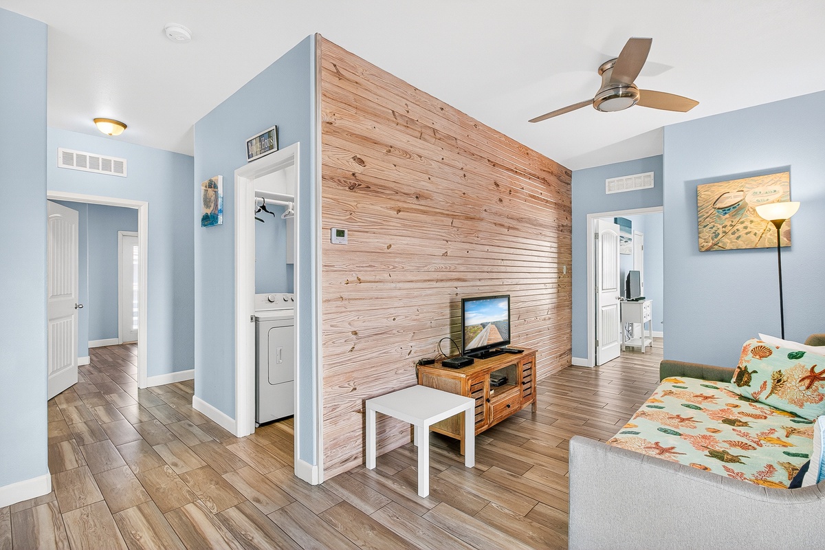 Unwind in your coastal-inspired living room featuring warm wood accents and beachy décor that instantly puts you in vacation mode.