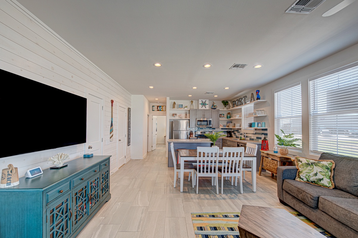 Relax in your open-concept living space where coastal charm meets modern comfort, complete with full kitchen and dining for memorable meals together.