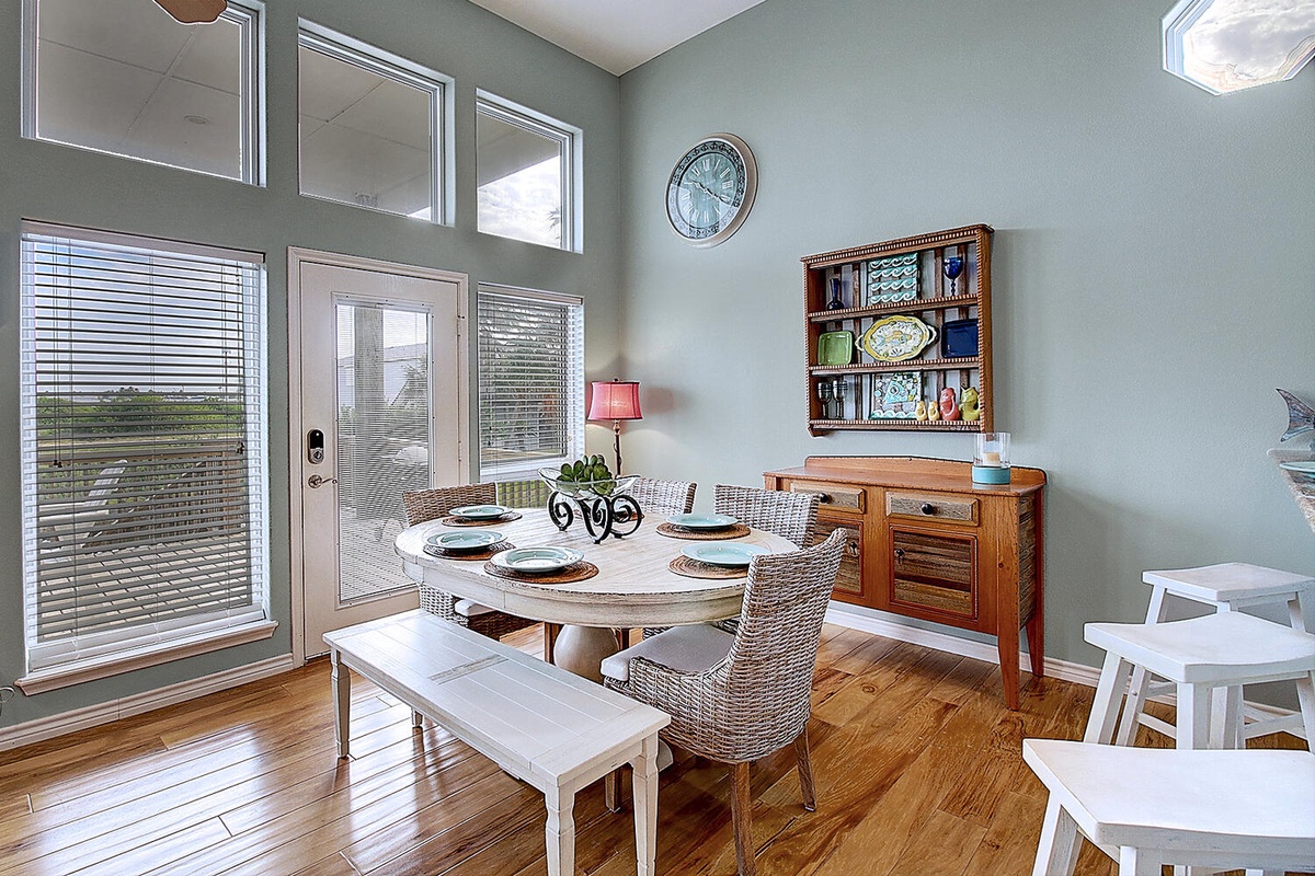 Gather around your bright dining space where morning coffee and evening meals feel special with warm wood floors and garden views.