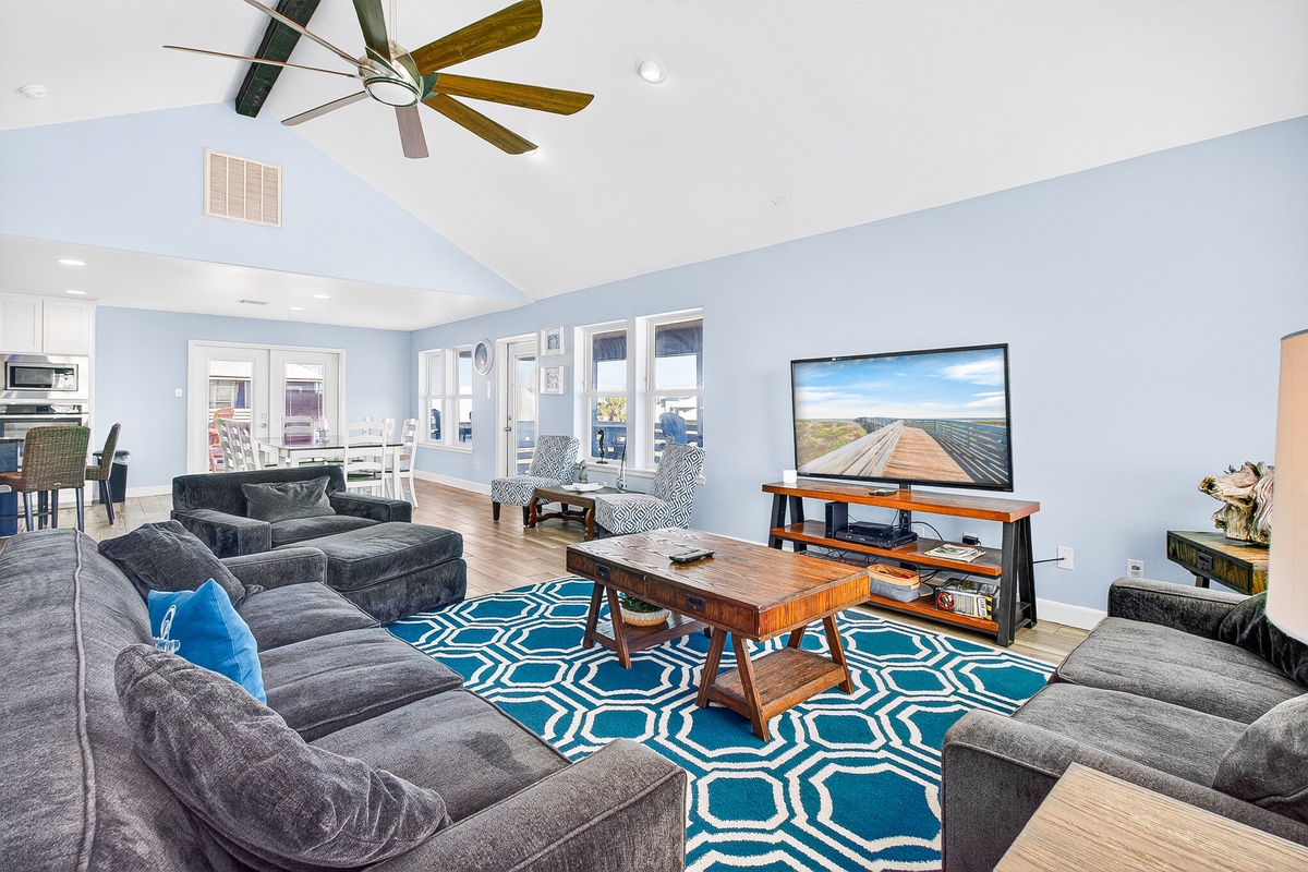 Sink into plush sofas while enjoying your favorite shows on the large TV in this bright, airy living space.