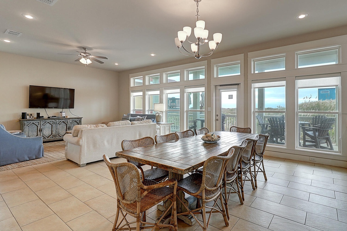 Gather around this spacious dining table where your group can share meals while enjoying natural light streaming through expansive windows.