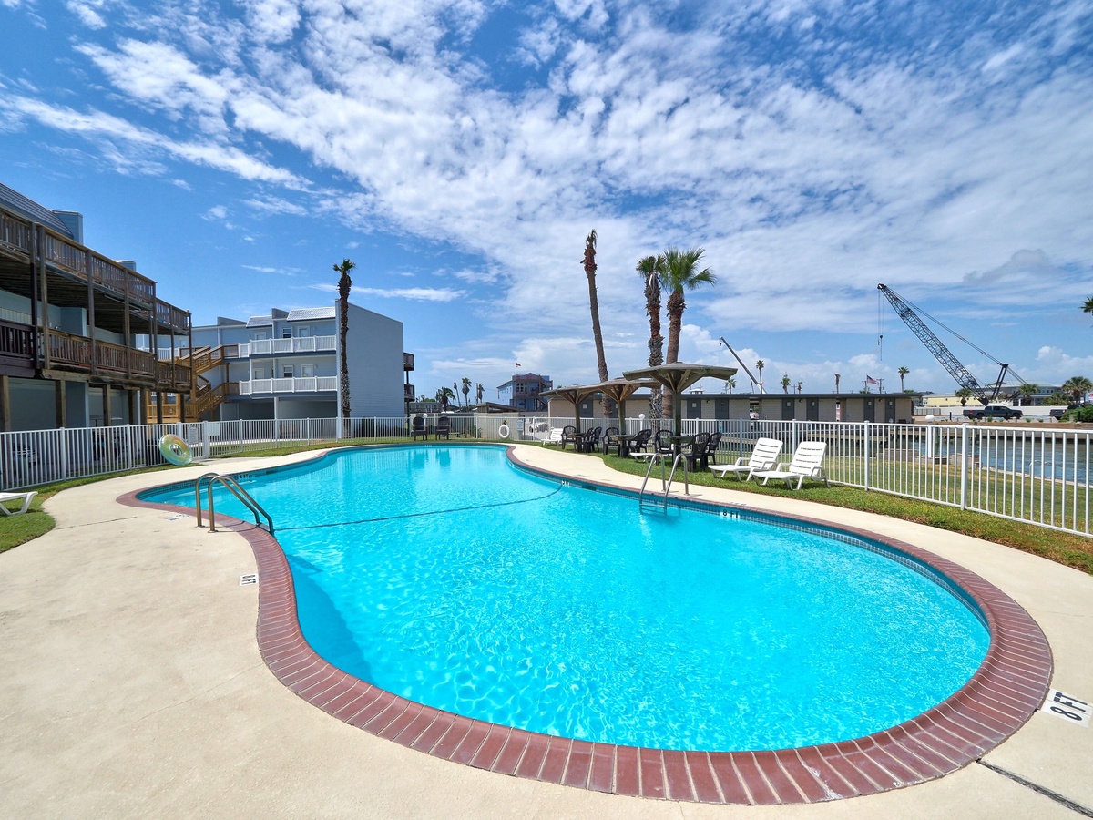 Take a refreshing dip in your private pool surrounded by palm trees and sunny skies—your perfect vacation oasis awaits.