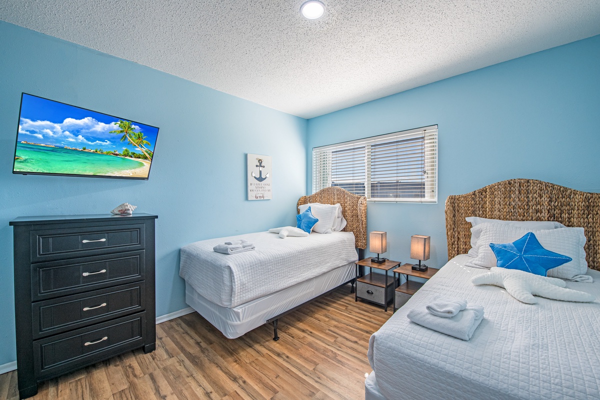 Drift off to peaceful sleep in your cozy twin bedroom, where coastal blues and warm touches create the perfect retreat.