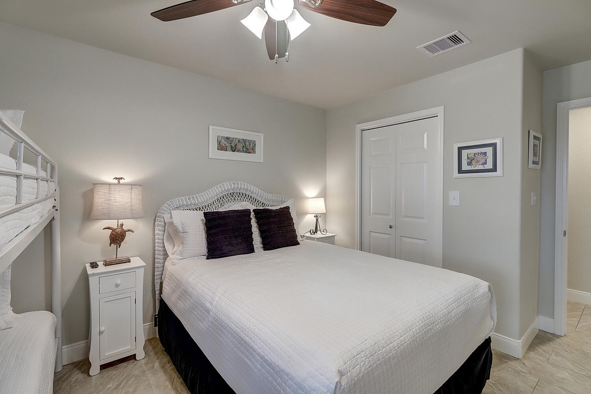 Drift off peacefully in your cozy bedroom with soft linens, gentle ceiling fan breezes, and thoughtful coastal touches.