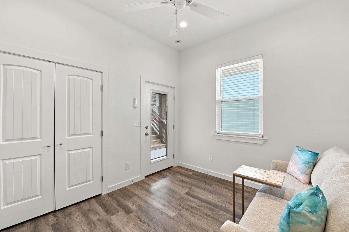 Cozy third bedroom with queen sleeper sofa, en-suite bathroom and calming ocean-inspired accents.