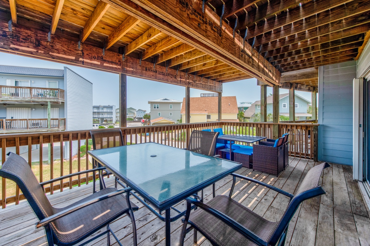 Gather around your private covered deck with dining table and lounge seating—perfect for morning coffee or evening meals overlooking the neighborhood.
