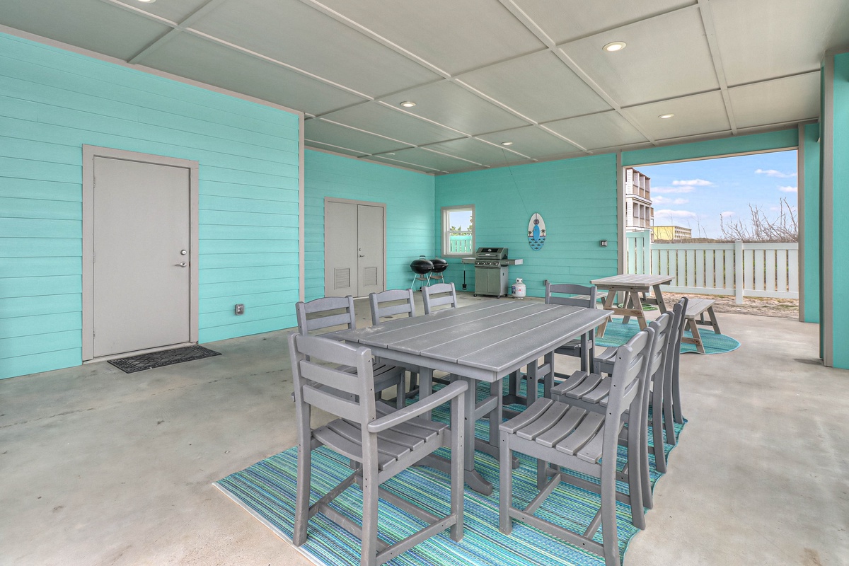 Gather your group around this spacious covered patio for memorable meals with cheerful turquoise walls and beach views.
