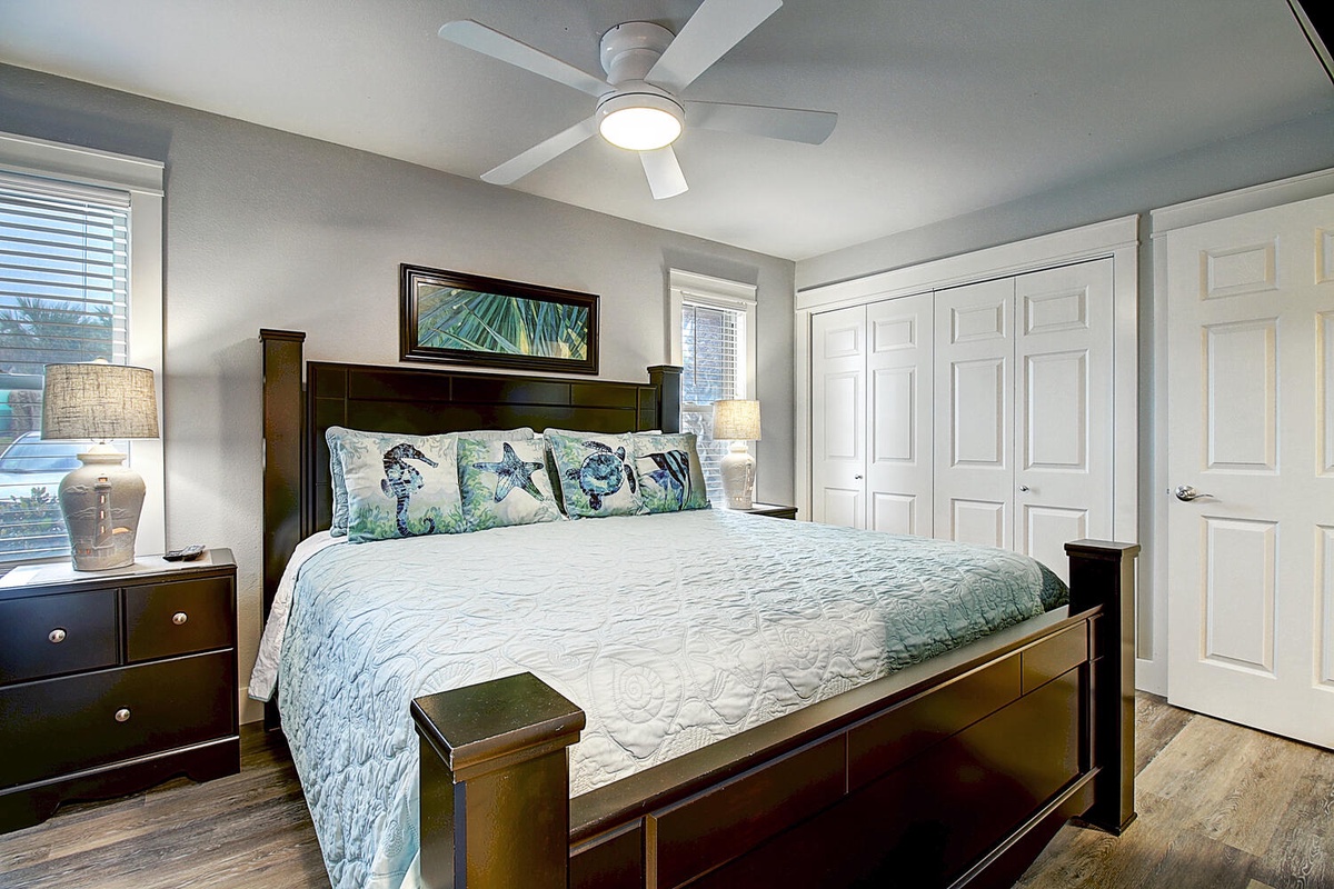Sink into the plush king bed surrounded by tranquil coastal decor and ample storage in your private sanctuary.