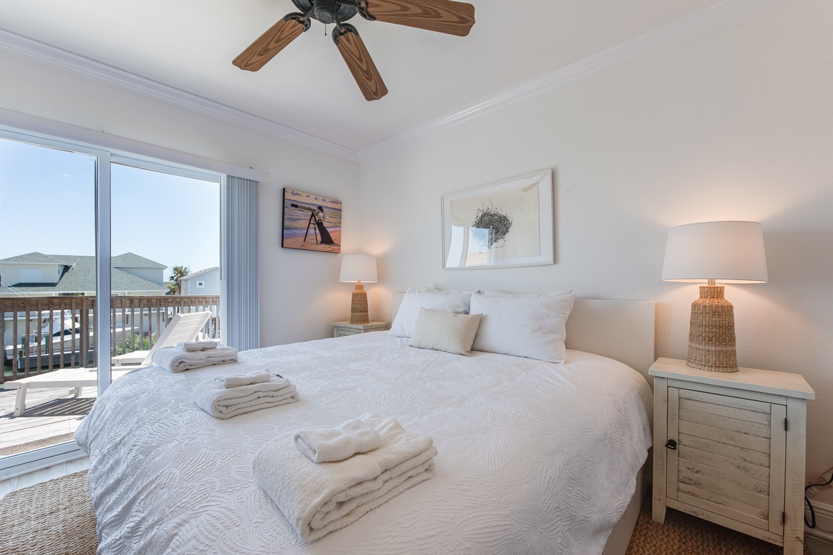 Wake up to ocean breezes in your serene bedroom, where soft linens and seaside charm create your perfect coastal retreat.