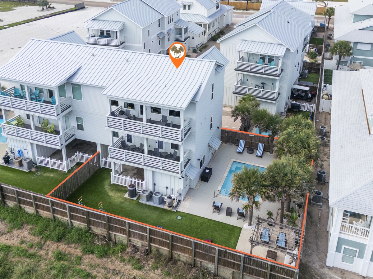 Modern beachside vacation rental with private pool and tropical landscaping in a quiet residential neighborhood.