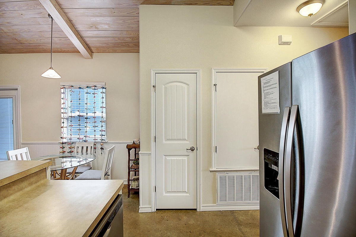 You'll love preparing meals in this spacious kitchen with gleaming stainless steel appliances and exposed wood beam ceilings that add rustic charm.