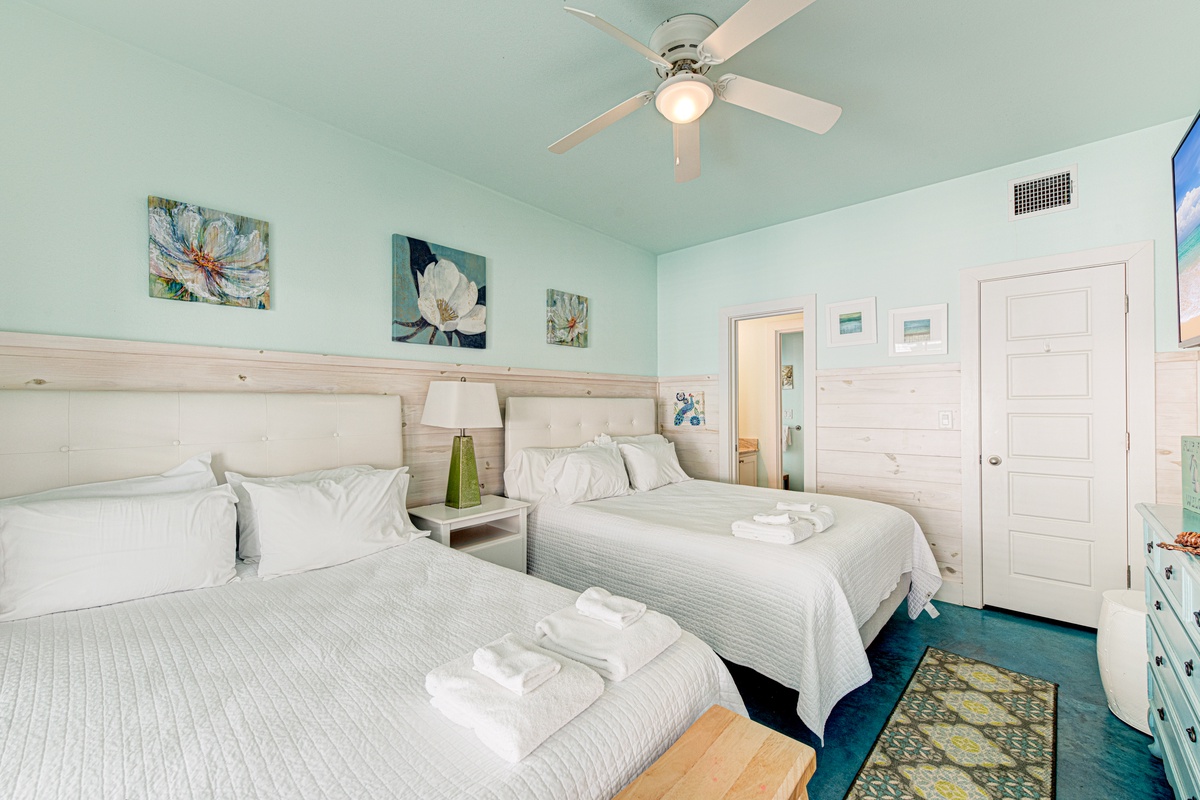 Drift off in your peaceful twin bedroom with soft linens, calming coastal artwork, and fresh towels waiting for you.