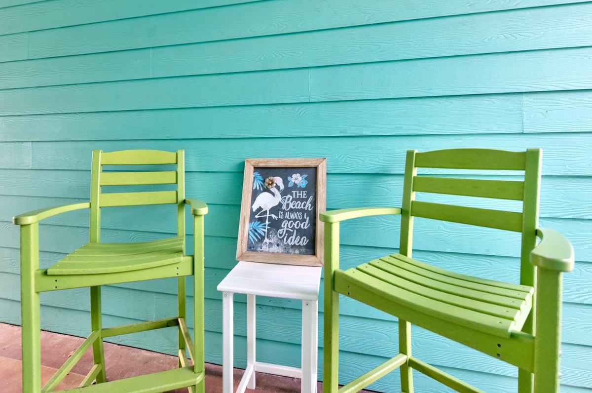 Settle into these cheerful green chairs and soak up the coastal vibes on your private outdoor deck.