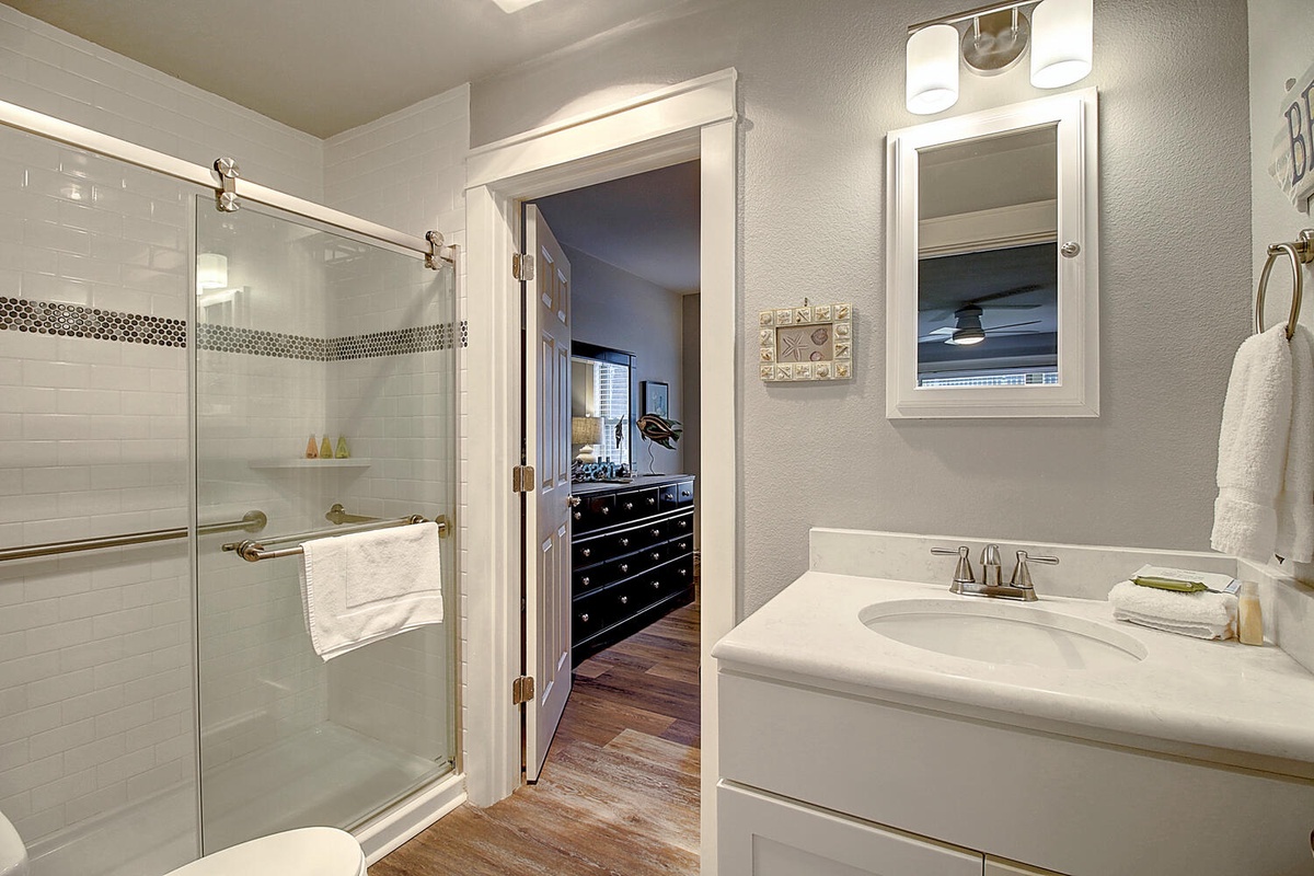 Refresh in your private ensuite with elegant tile work, modern glass shower, and thoughtfully arranged amenities.