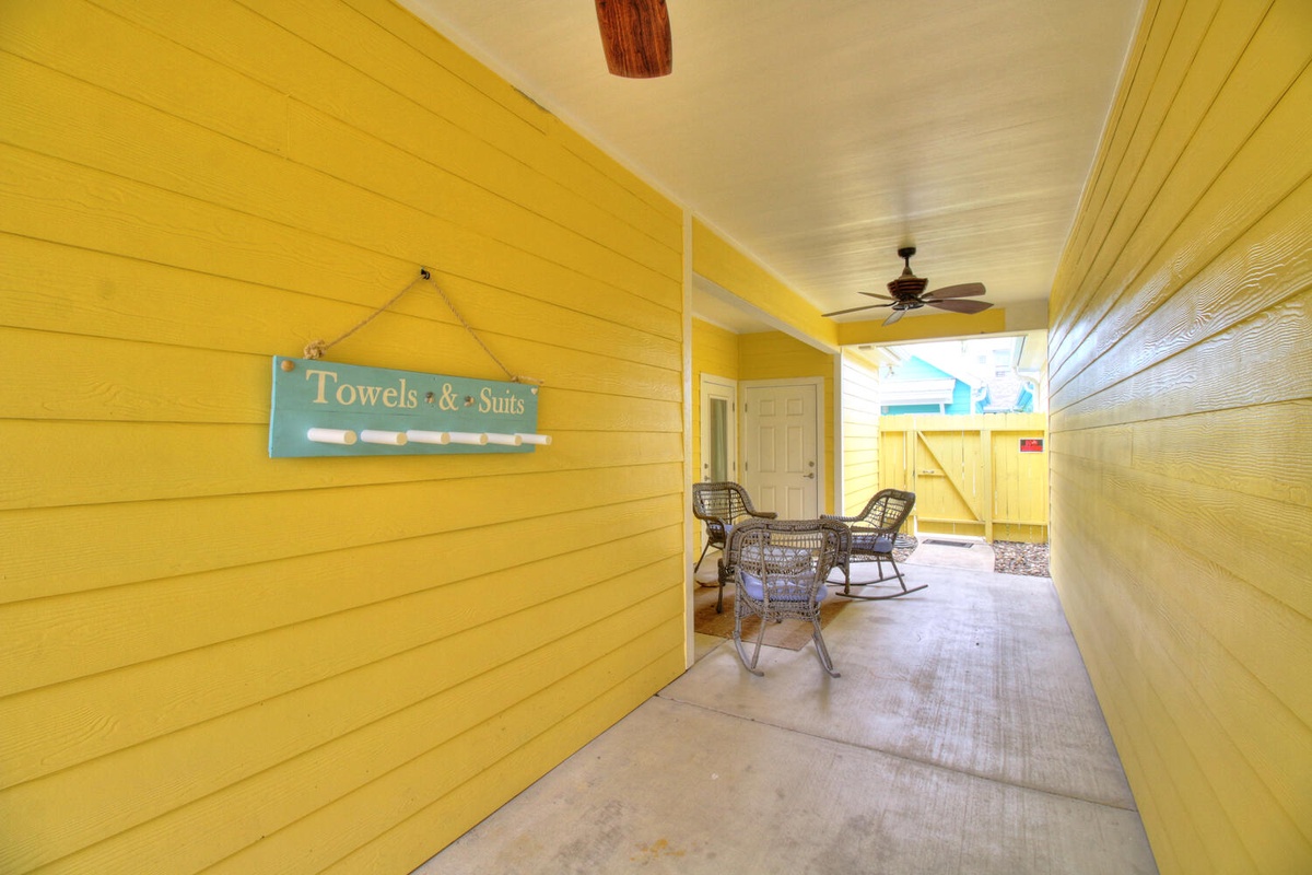 Your cheerful covered patio welcomes you with wicker seating and thoughtful touches like towel hooks for beach days.