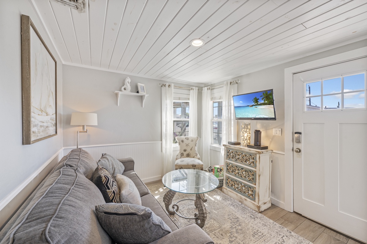 Sink into your cozy living room where coastal charm meets comfort. Relax on the plush sofa while enjoying your favorite shows.
