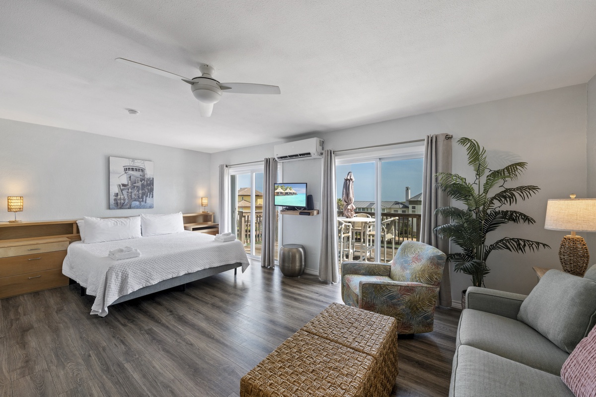 Unwind in your bright, airy retreat with coastal charm, comfortable seating, and balcony doors opening to refreshing ocean breezes.