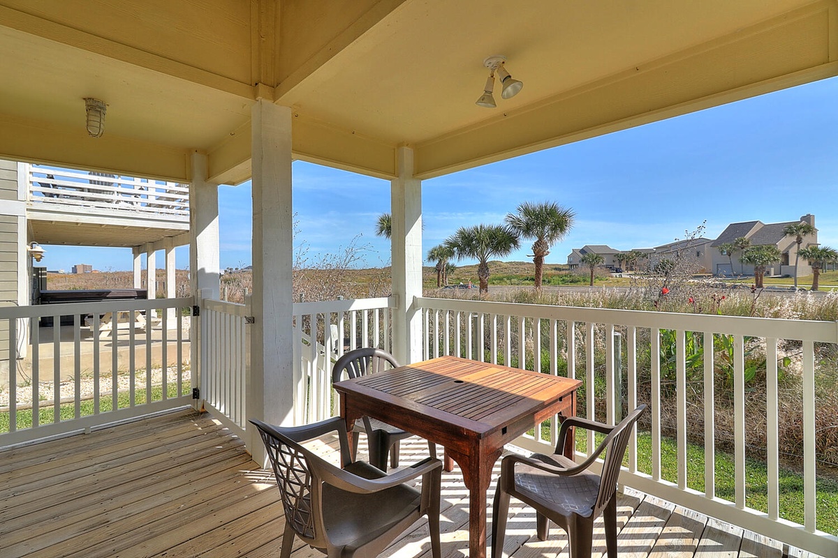 Enjoy morning coffee on your private covered balcony with coastal breezes and peaceful neighborhood views.